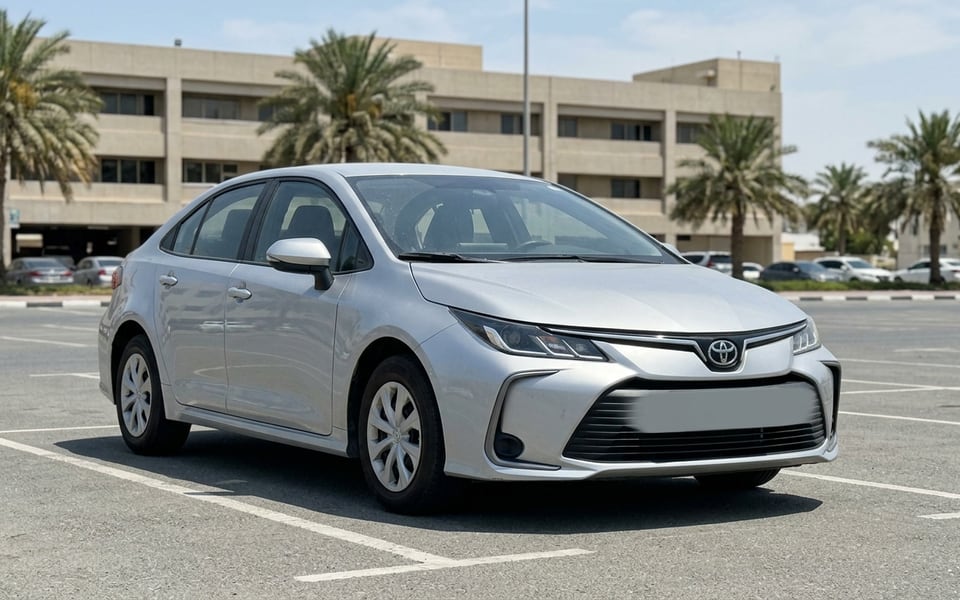 A phone photo of a silver Corolla in a Dubai car park, the kind of shot a render360 wrap render starts from